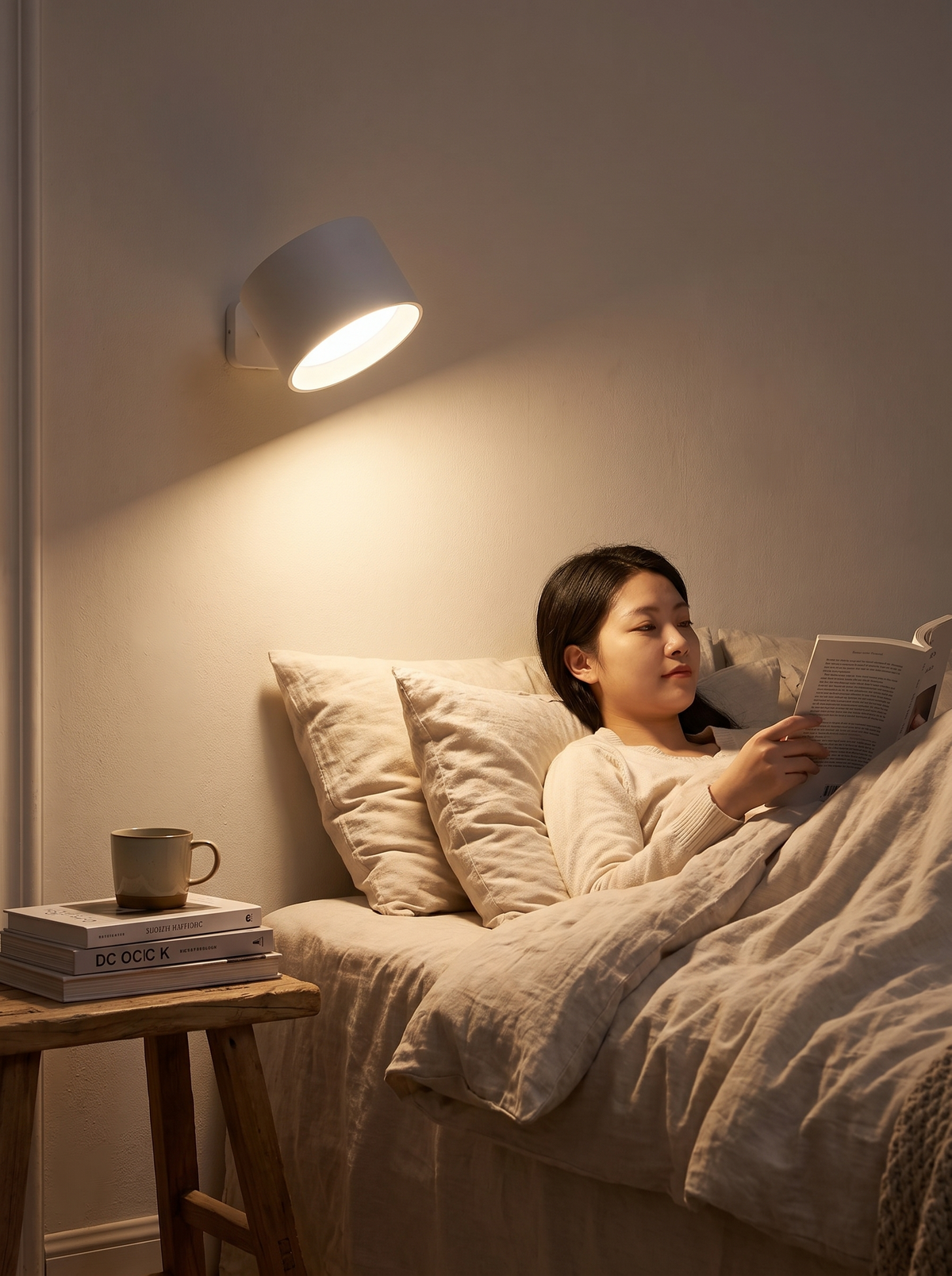Rechargeable wall light mounted beside a bed