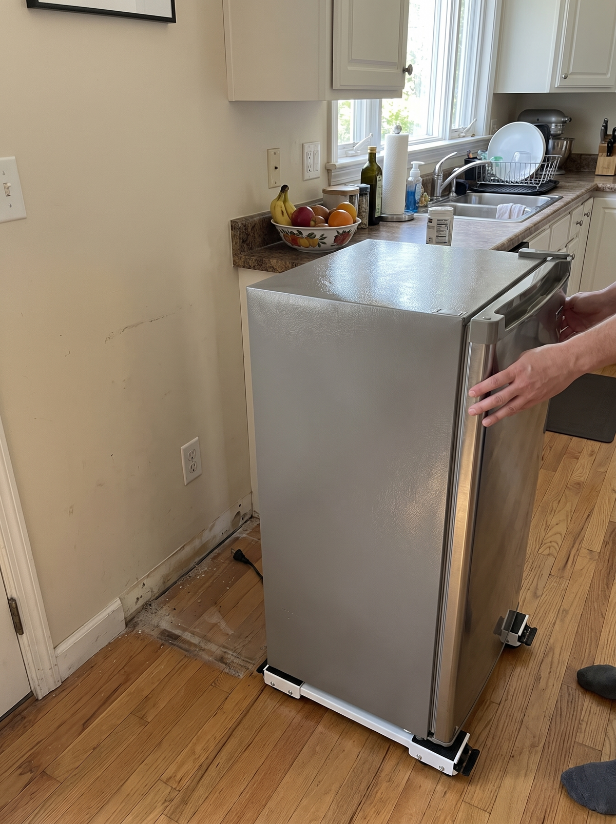 Appliance rollers moving a fridge out from the wall